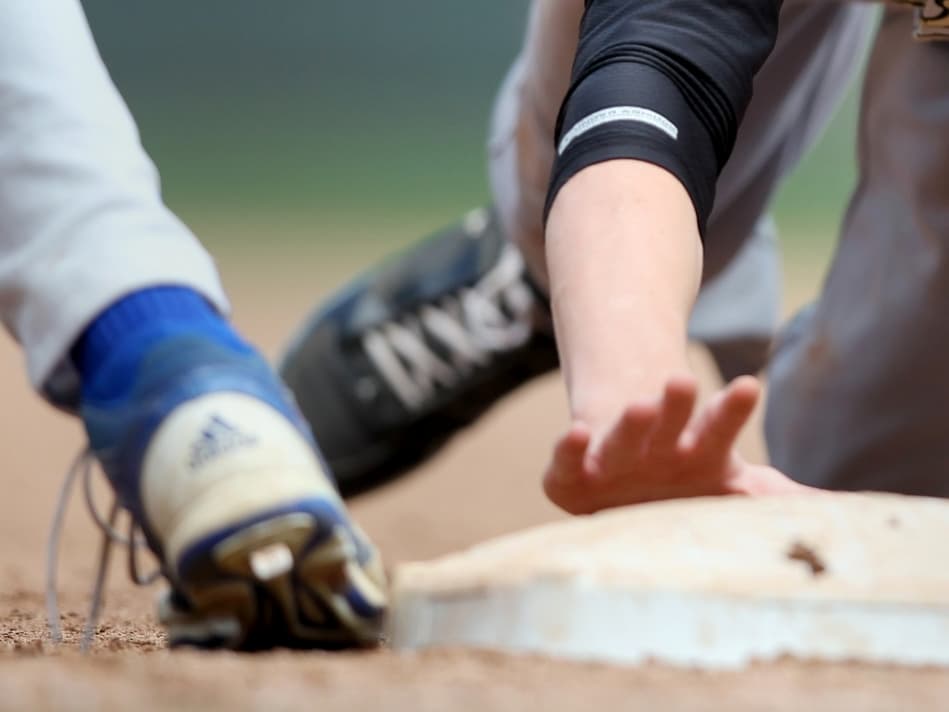 Perham's Jake Lueders (6) slides into first base after being caught trying to steal in the Kasson-Mantorville vs. Perham Class AA boys baseball high school championship at Target Field on Monday, June 17, 2013. Kasson-Mantorville won the championship game 8-1.