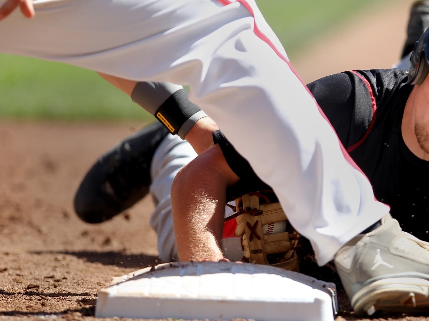 Osakis' Austin Rollag (11) slides into first base after being caught trying to steal in the Osakis vs. BOLD, Olivia Class A boys baseball high school championship at Target Field on Monday, June 17, 2013. BOLD ,Olivia won the championship game 3-0.